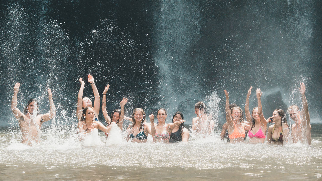 Dreamsea Surf Camp Costa Rica | Blog Header Image | Group of individuals playing in the water and splashing