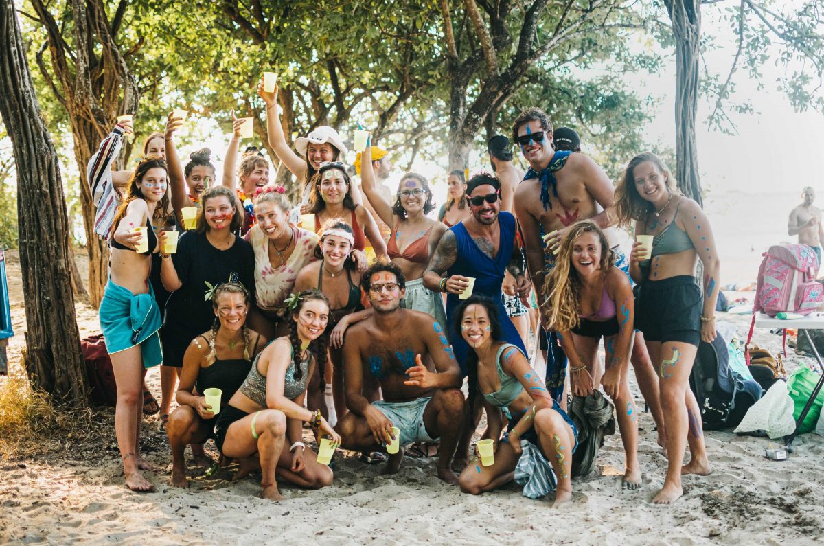 Dreamsea Costa Rica Surf Camp | backpacking, travel, hostel, surf, and yoga camp | Media Files | Lifestyle Image of Surf and Yoga Camp Resort | group of individuals posing for a photo on a Tamarindo Costa Rica beach