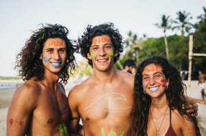 Dreamsea Costa Rica Surf Camp | backpacking, travel, hostel, surf, and yoga camp | Media Files | Lifestyle Image of Surf and Yoga Camp Resort | two guys and a girl with face paint on a beach in Tamarindo Costa Rica