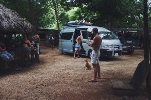 Dreamsea Costa Rica Surf Camp | backpacking, travel, hostel, surf, and yoga camp | Blog | picture of a group of people standing around dreamsea surf camp site in tamarindo costa rica