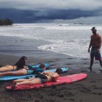 Dreamsea Costa Rica Surf Camp | backpacking, travel, hostel, surf, and yoga camp | Blog | picture of a man teaching 3 girls on surfboards how to surf