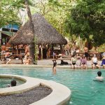 Dreamsea Costa Rica | Main Footer Background Image | Image of a group of people hanging around a pool and cabana